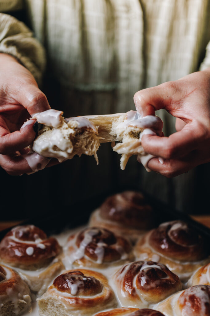 Tearing open the coconut buns with drippy sauce