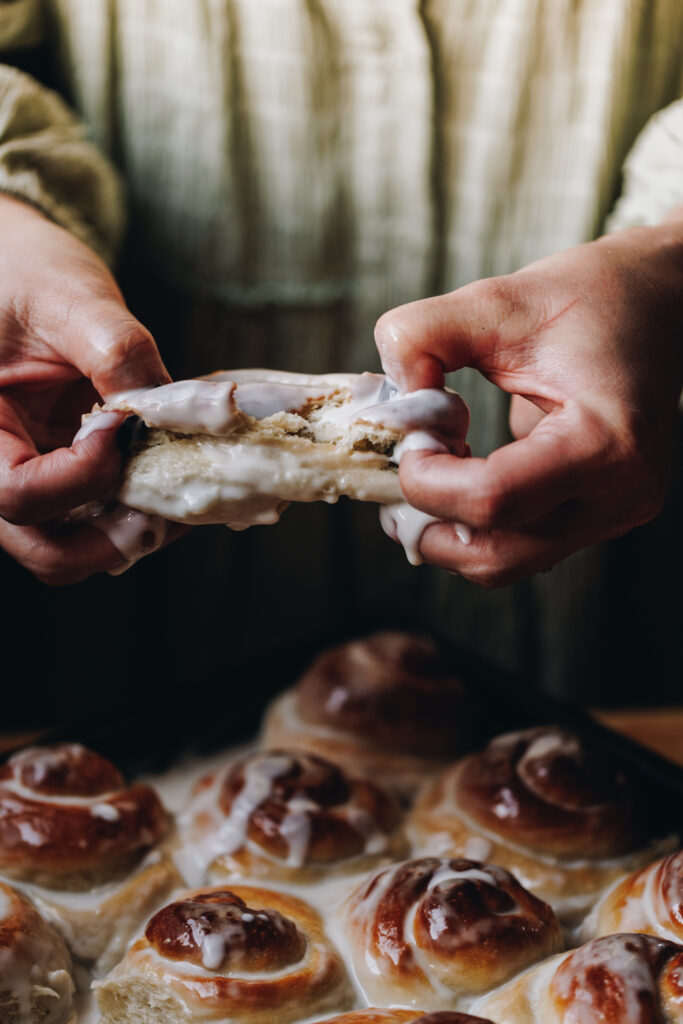 Tearing open the coconut buns with drippy sauce