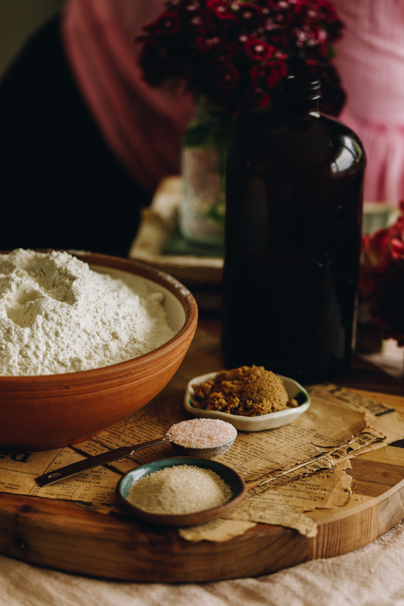 No-knead Bread Loaf ingredients are in different vintage bowls and are sitting on a wooden board.