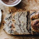 A top shot reveals the spiced banana loaf sliced open revealing the spiced sugar running through the loaf.