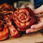 One sticky maple scroll is being pulled by a hand, other scrolls are stuck to it. The sticky glaze is all over the scrolls.