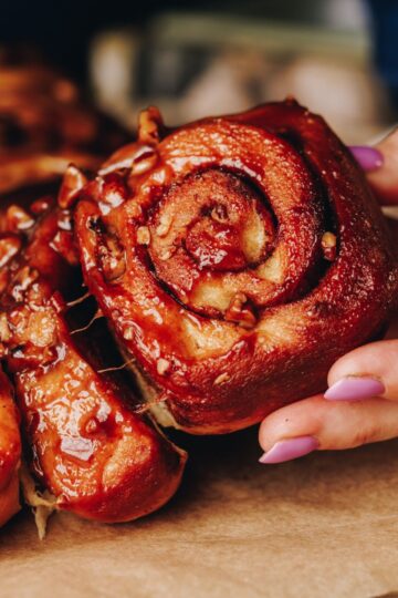 One sticky maple scroll is being pulled by a hand, other scrolls are stuck to it. The sticky glaze is all over the scrolls.