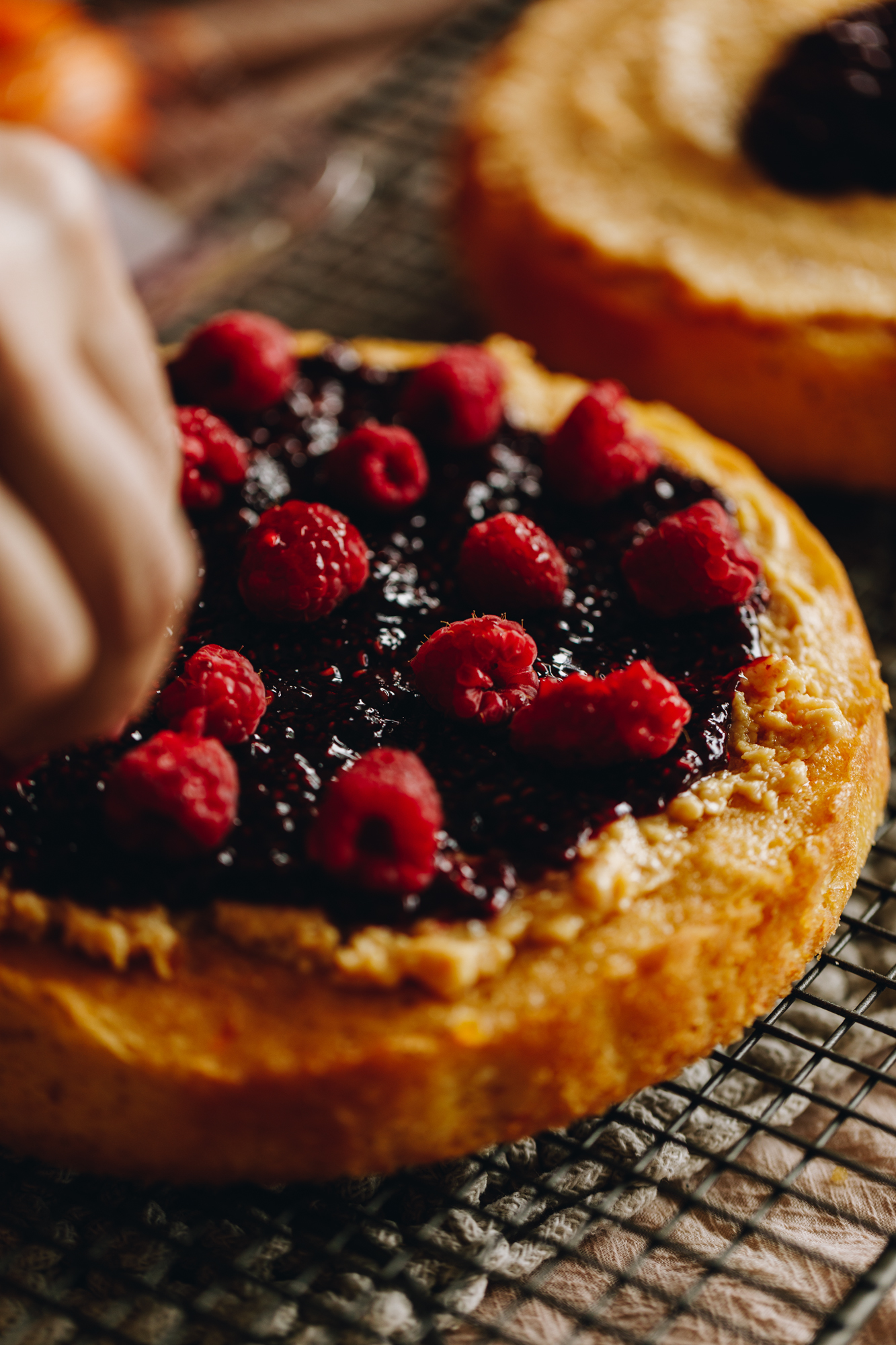 The white chocolate ganache, raspberry jam and fresh raspberries are added on to the freshly baked sponge.