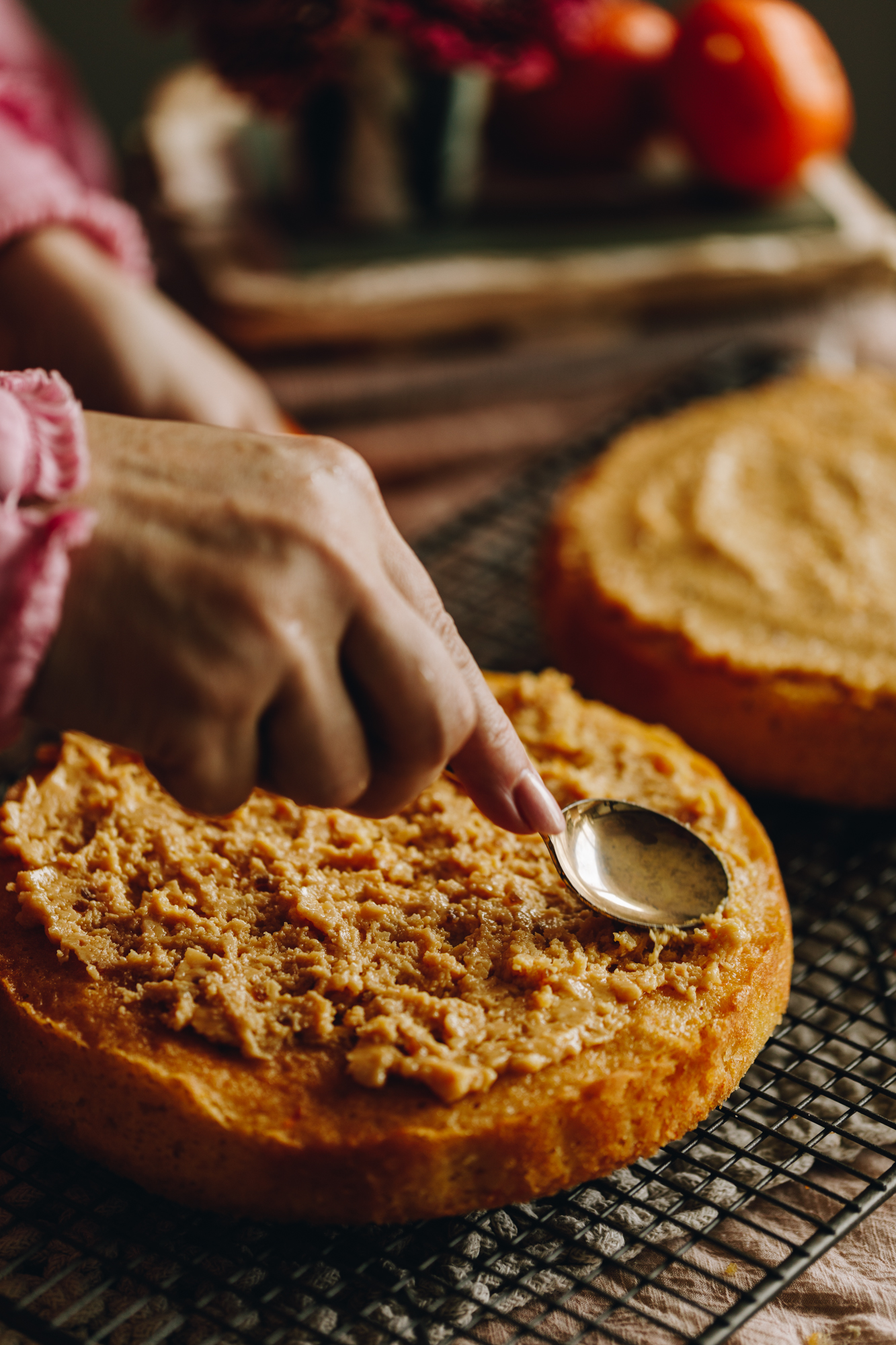 The white chocolate ganache is being spread on to the freshly baked sponges of the Raspberry Lamington Cake.