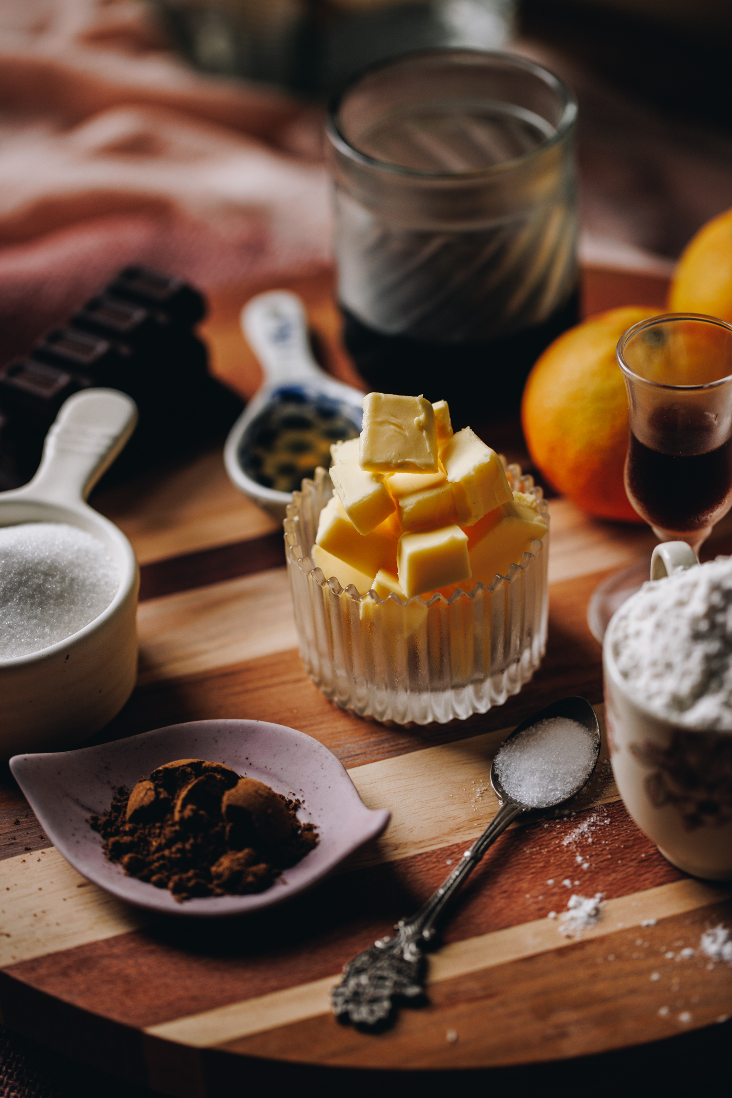 Homemade Brandy Snaps ingredients are in different vintage bowls and are sitting on a wooden board.
