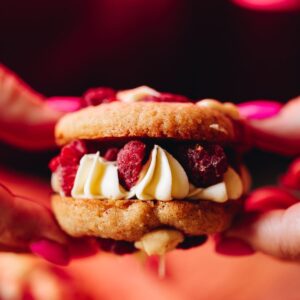Close up of a filled Lemon Raspberry Cookie Sandwich.