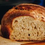 Close shot of Cottage Cheese Cumin Loaf has been cut open to reveal the soft interior.