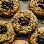 A close shot of 5 Pistachio and chocolate cookies reveal the gooey chocolate centre.