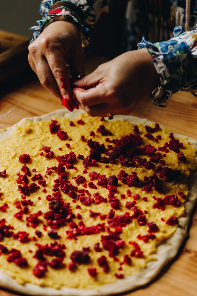 Frozen raspberries sprinkled on custard