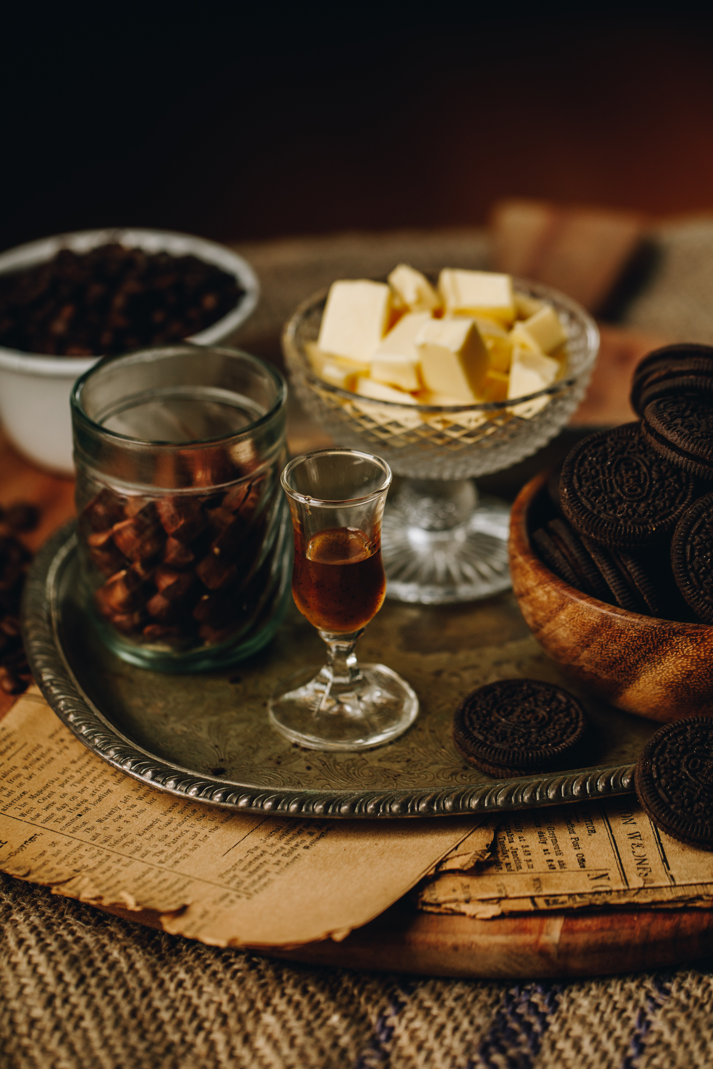 Chilled Mocha Cheesecake base ingredients are in different vintage bowls and are sitting on a wooden board.