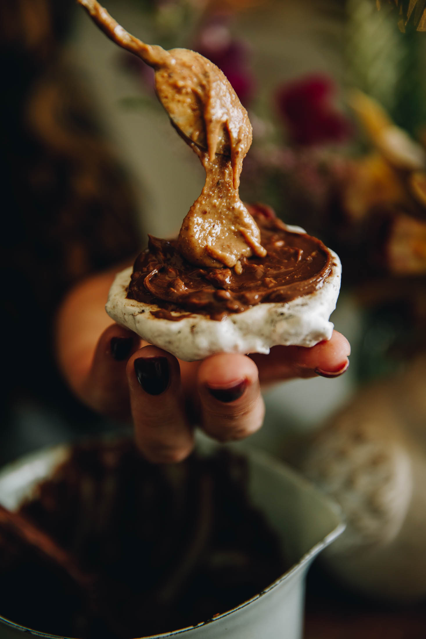 A forgotten meringue cookie smeared with chocolate and topped with almond butter.